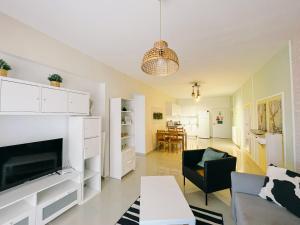 a living room with a fireplace and a couch at Spacious & Modern 1 Bedroom Holiday Home in Perivolia tou Trikomou +13 photos