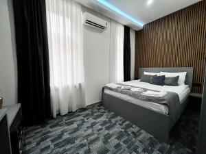 a bedroom with a bed in a room with a window at Residence Inn Orijent in Sarajevo