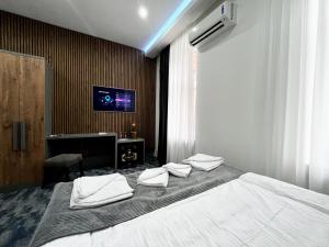 a bedroom with a bed with white towels on it at Residence Inn Orijent in Sarajevo +44 photos