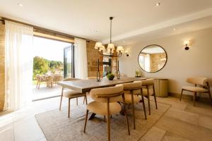 a dining room with a table and chairs and a mirror at Sandfield House in Whitby
