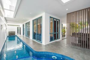 a swimming pool in a house with a house at Cove Villa Prana in Jimbaran