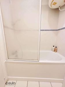 a shower with a glass door in a bathroom at Studio chaleureux in Laon +16 photos