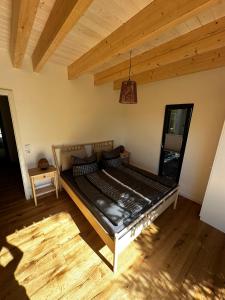 a large bed in a room with a wooden floor at Ferienwohnung STENJA - made of wood in Dresden