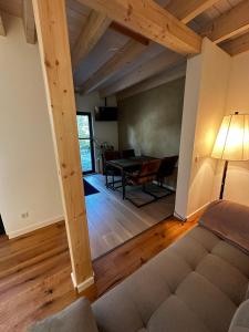 a living room with a couch and a table at Ferienwohnung STENJA - made of wood in Dresden