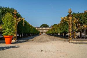 an ornate iron gate leading to a large building at Le superbe des Dominicains in Nancy +11 photos