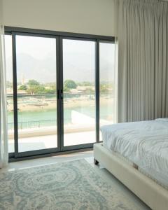 a bedroom with a bed and a large window at 3BR villa and maid room by escape time in Sharm