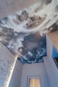 a ceiling with a painting of the sky at Suite Intemporelle in Montagnac