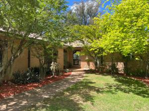 a brick house with a pathway leading to the front yard at Mountain View Blue Mountains in Kurrajong