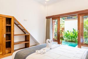 Postel nebo postele na pokoji v ubytování Ubud Ayu