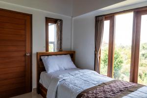 Postel nebo postele na pokoji v ubytování Ubud Ayu