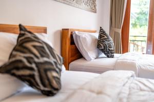 Postel nebo postele na pokoji v ubytování Ubud Ayu