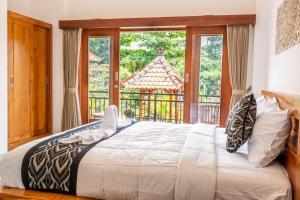 Postel nebo postele na pokoji v ubytování Ubud Ayu