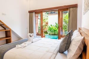 Postel nebo postele na pokoji v ubytování Ubud Ayu
