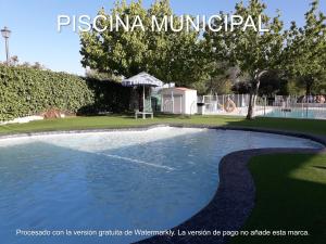 a swimming pool in the middle of a park at La Payana, Sierra de Grazalema Consultar precios en LA PAYANA Prado del Rey in Prado del Rey