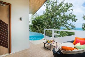 an outdoor living room with a view of the ocean at Cocohut Beach Resort Koh Phangan in Haad Rin