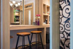 a bar with two stools sitting at a counter at Cocohut Beach Resort Koh Phangan in Haad Rin