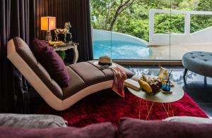 a living room with a couch and a table at Cocohut Beach Resort Koh Phangan in Haad Rin