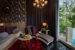 a living room with a couch and a table at Cocohut Beach Resort Koh Phangan in Haad Rin