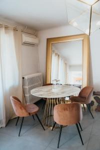 a table and chairs in a room with a mirror at Domaine Montserrat in Le Luc