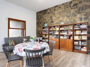巴哈马尔La esquina del cactus的一间带桌椅和书架的餐厅