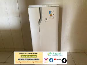 a white refrigerator sitting next to a wall at Cabo Frio - Braga - Kitnets - Aluguel Econômico in Cabo Frio