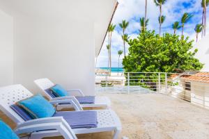 a balcony with chairs and a view of the beach at Prime Ocean View Punta Cana Apartments - 3-Bedroom Getaway with Private Terrace on Bávaro Beach in Punta Cana