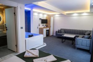 a living room with a couch and a table at Safir Suit in Nazilli