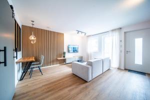 a living room with a couch and a table at Coblenz Suites - Deluxe Apartments in Koblenz
