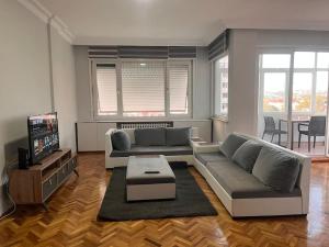 a living room with a couch and a tv at Spacious flat with wide view in Istanbul