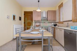 a kitchen with a table and chairs in it at Thea Dikella in Dhíkella