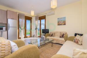 a living room with couches and a table at Thea Dikella in Dhíkella