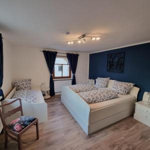 a bedroom with two beds and a couch at Ferienhaus Emma in Bundorf
