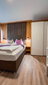 a bedroom with a large bed and a wooden floor at Sylpaulerhof-Zimmer Deluxe in Sankt Michael im Lungau +21 photos