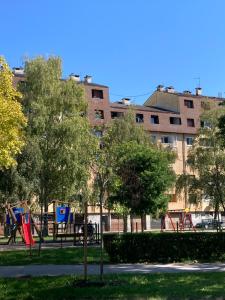 a park with a playground in front of a building at STUDIO APP STELLA Jarun Zagreb SELF-CHECK-IN in Zagreb