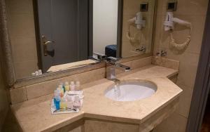 a bathroom counter with a sink and a mirror at Mineo Park Hotel in Istanbul
