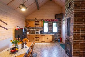 a kitchen with a table and a refrigerator and a stove at Natura Haziko in Izvoare
