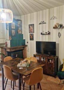 un soggiorno con un tavolo di legno e una televisione di La Casa di Gioia - perfetto rifugio di montagna ad Ateleta