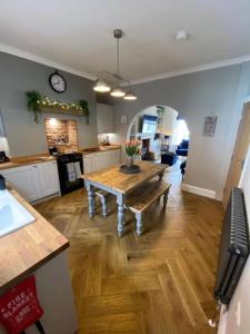 a kitchen with a wooden table in a room at Harbour Heights Whitby in Whitby