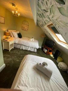 a hotel room with two beds and a window at Harbour Heights Whitby in Whitby