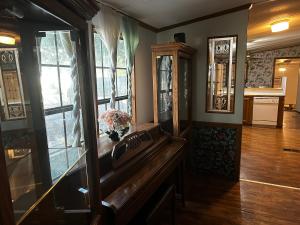 a living room with a wooden table and windows at Woolen Lake House in Columbia +3 photos
