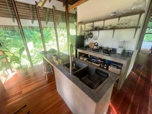 a kitchen with a stove and a sink in a room at Dalakit House Villa Two in Siquijor
