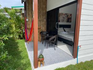 a balcony with a bed and a table and chairs at Pavana Boutique & Kite Bungalows in Thongsala