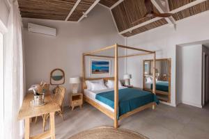 Кровать или кровати в номере Cotton Bay Resort & Spa