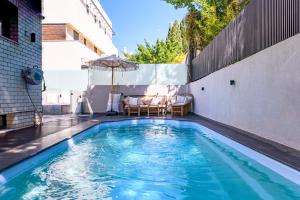 a swimming pool on the side of a building at Rokah Luxury Villa at Ramat HaHayal in Tel Aviv