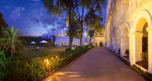 a walkway in front of a building at night at The Grand Imperial - Heritage Hotel in Agra