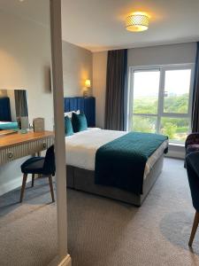 A bed or beds in a room at Arklow Bay Hotel