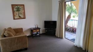 a living room filled with furniture and a fire place at Hobson's Choice Motel in Dargaville