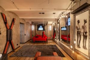 a room with red beds and a red couch at Royal Hot Jucuzzi Apartment in Lviv
