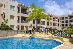 a swimming pool in front of a building at Oliva Poolside Residence by Nomads in Paphos