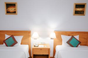 Postel nebo postele na pokoji v ubytování Petro Hotel